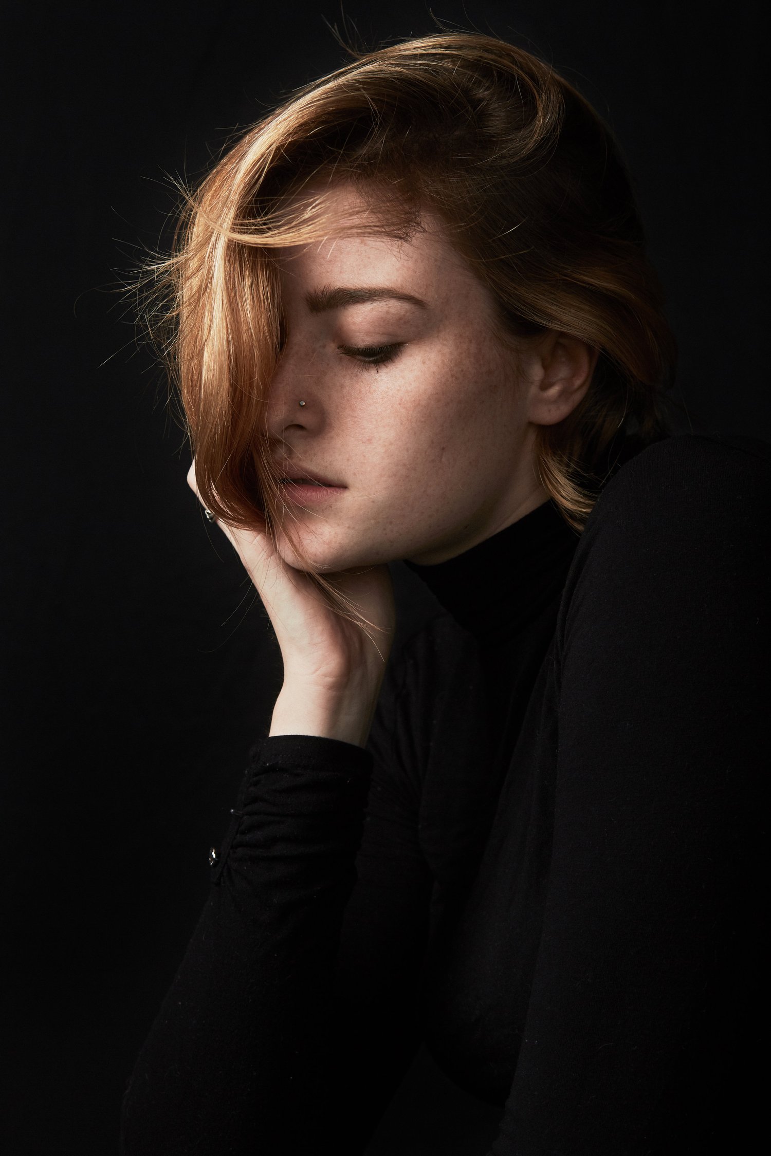 Studio portrait with warm light across the face