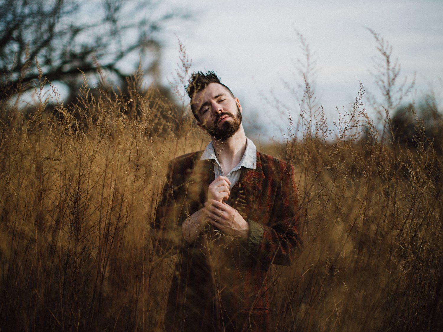 Portrait of a man among dry grasses